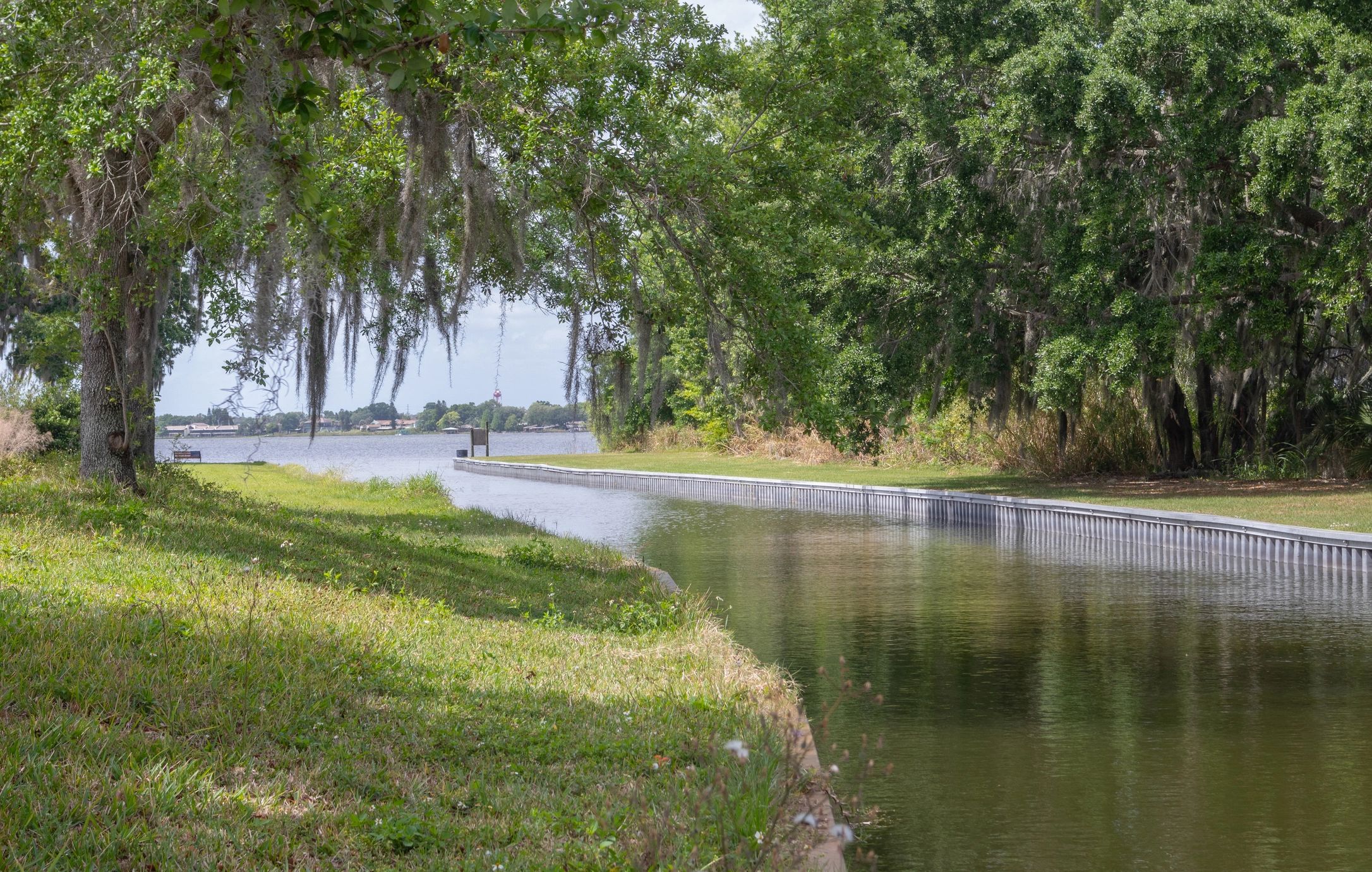 Florida canal and neighborhood waterway with grassy banks