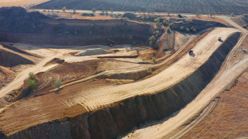 Aerial view showing arid quarry with heavy machinery working