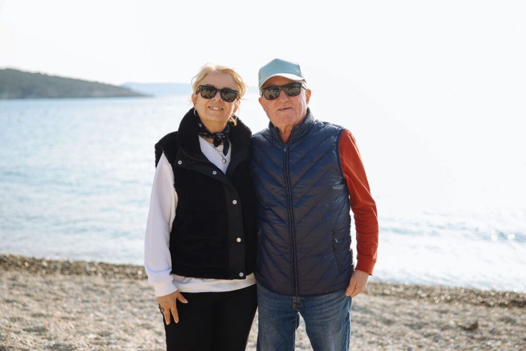 Smiling Senior Couple Posing Together on a Sunny Beach