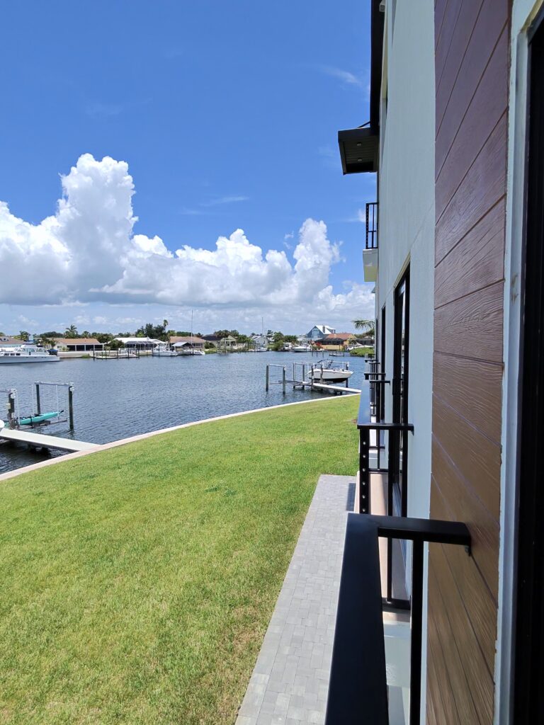 Palm trees and open lawn beside the water on the Florida Gulf Coast
