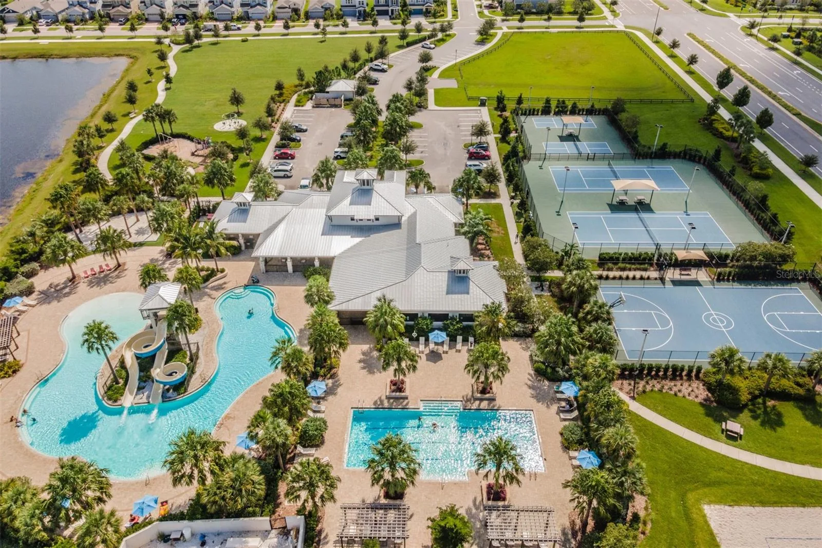 Aerial view of the Covington Park clubhouse, pool and tennis courts in Apollo Beach
