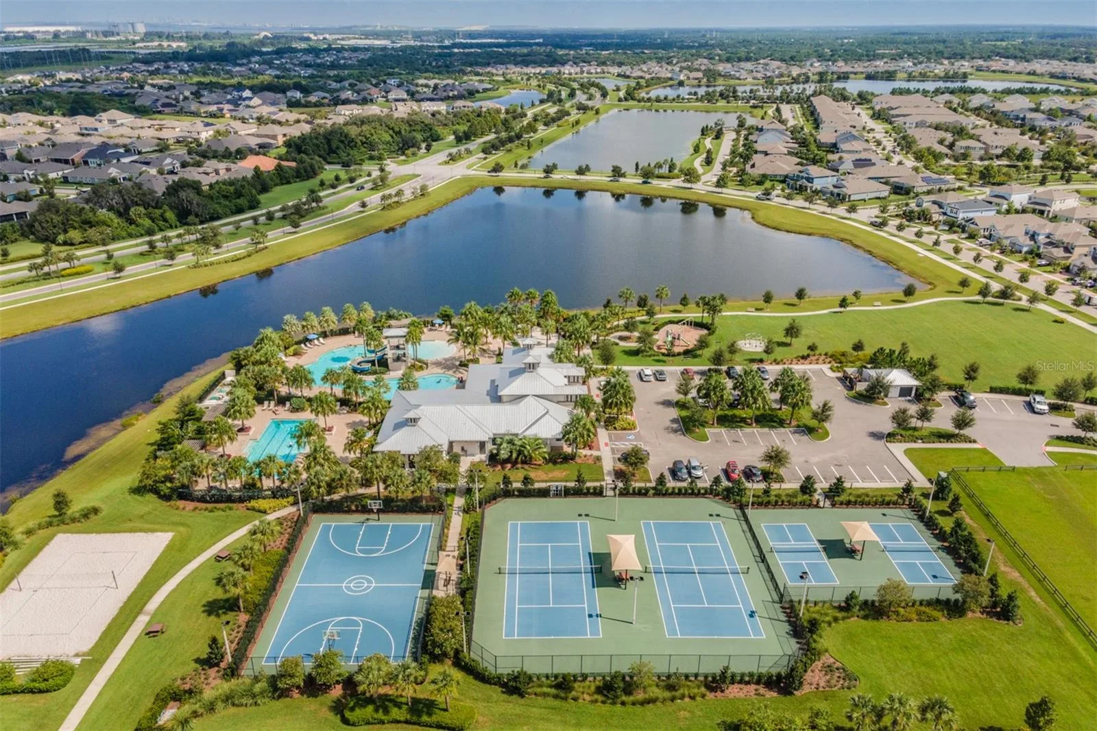Aerial view of the Covington Park tennis courts and retention pond in Apollo Beach