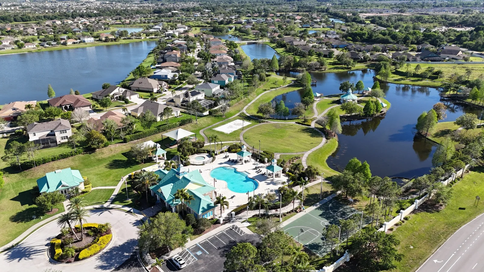 Aerial view of the Harbour Isles amenity center and pool beside the community lake in Apollo Beach