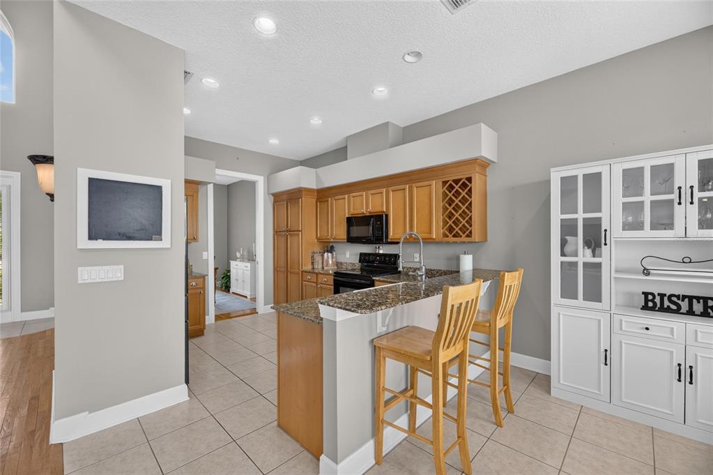 Kitchen with solid wood cabinets, granite and prep island