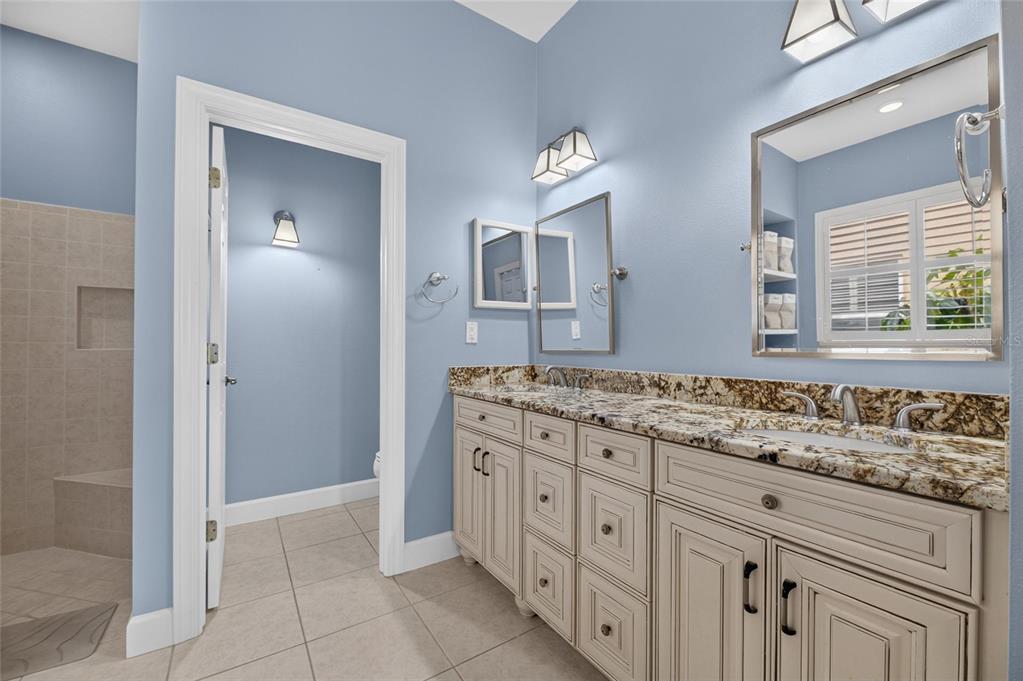 Primary bath with double vanities, soaking tub and tiled shower
