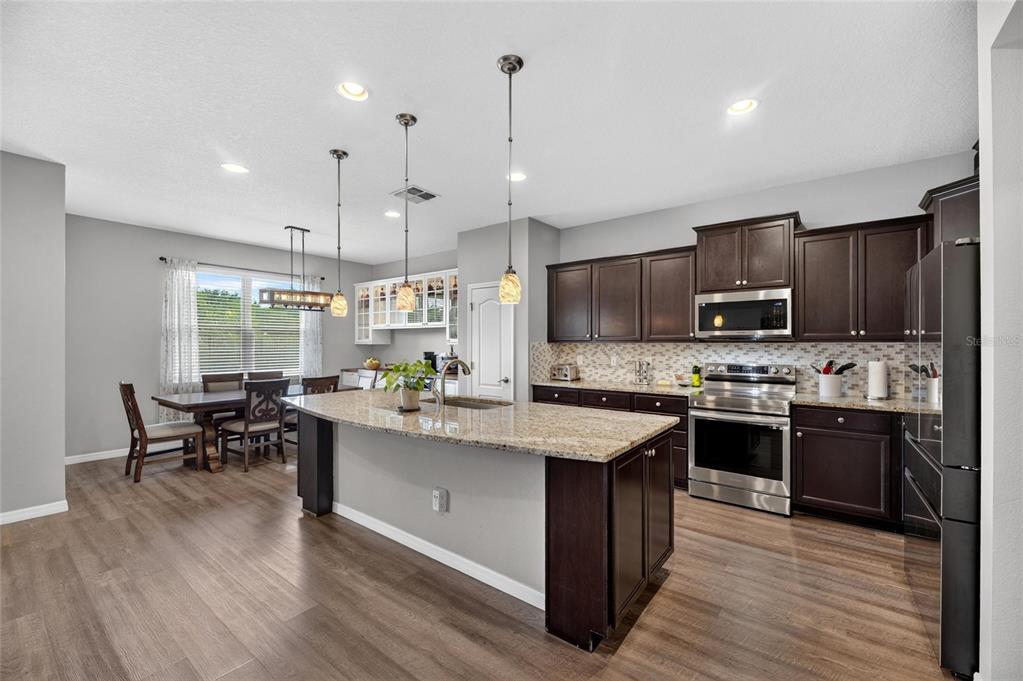 Kitchen with large island, stone counters and Samsung Bespoke appliances