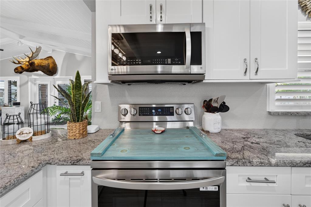 Gourmet kitchen with large island, stone counters and 2024 appliances
