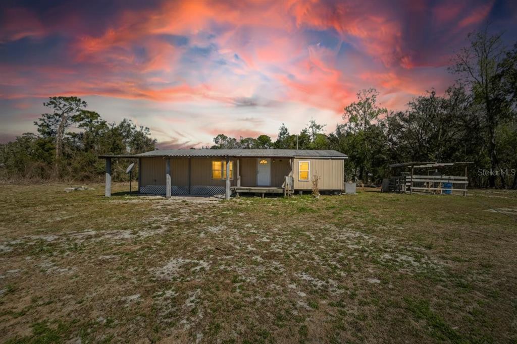 35238 Manuel Street in Webster at sunset across the open acreage