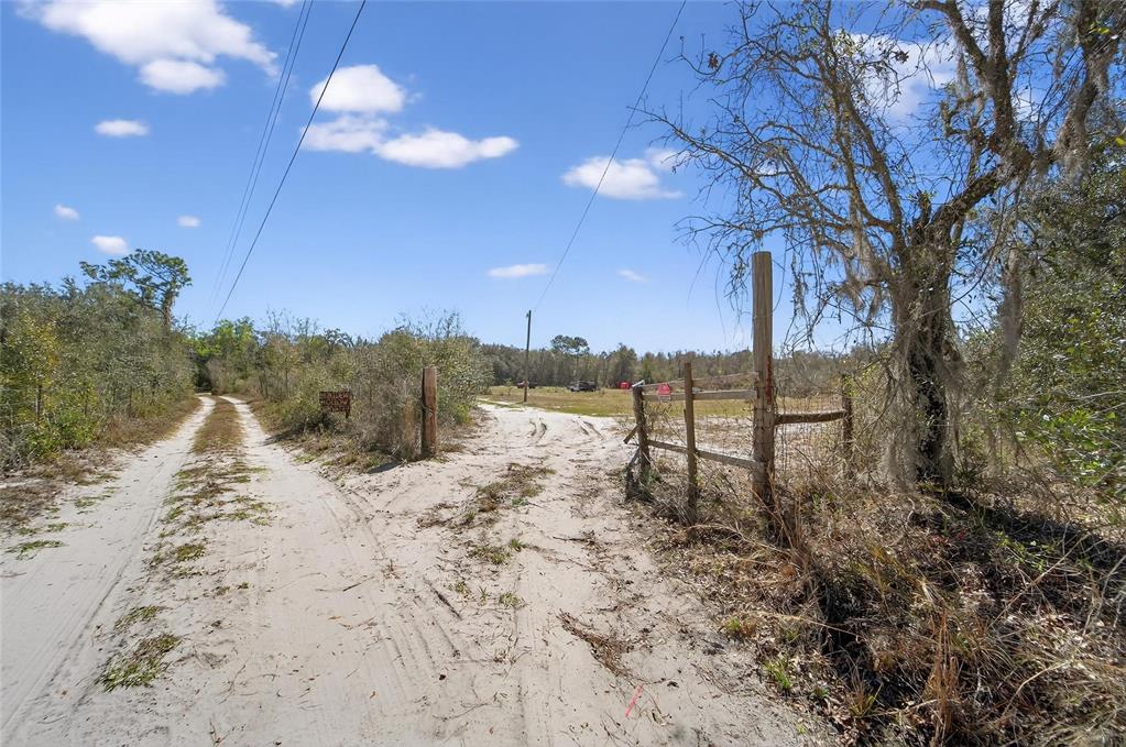 Sand road along the fence line at 35238 Manuel Street, Webster