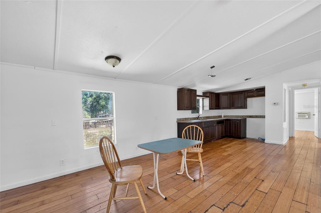 Living and dining area with wood floors at 35238 Manuel Street, Webster