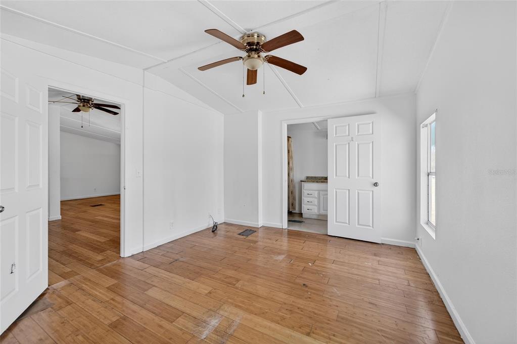 Bedroom with wood floors and a ceiling fan at 35238 Manuel Street, Webster
