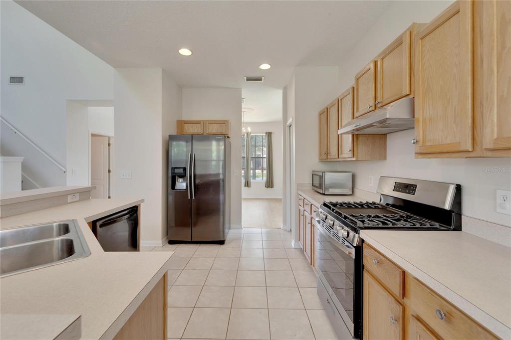 Kitchen with wood cabinets, island and gas range