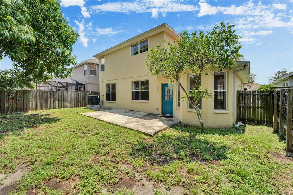 Fenced backyard with mature shade trees
