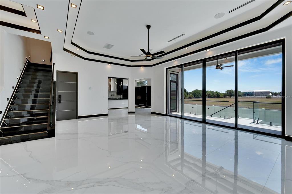 Living room with triple glass sliding doors at 517 Treviso Drive