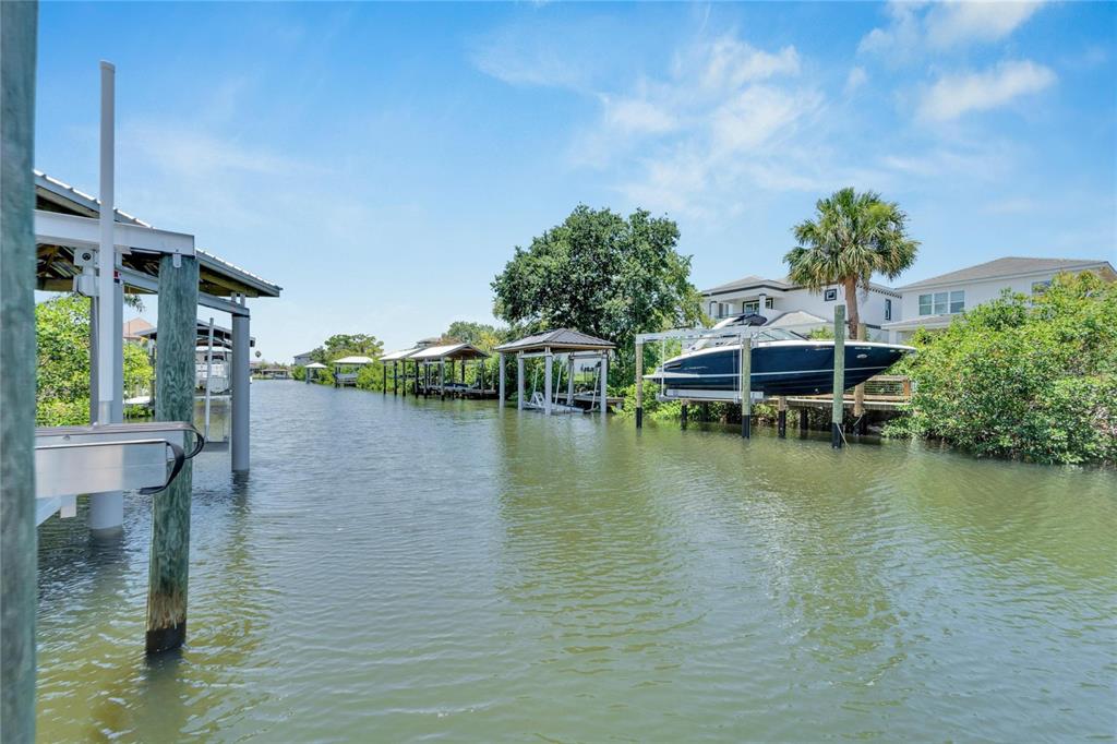 Saltwater canal behind 517 Treviso Drive in Treviso, Apollo Beach, with docks and lifts along the water