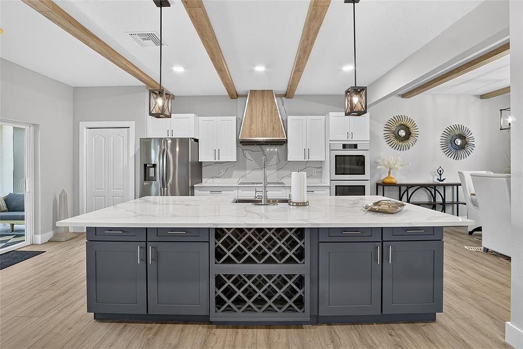Remodeled kitchen with custom cabinetry, a large island and exposed ceiling beams at 525 19th Street NW, Ruskin