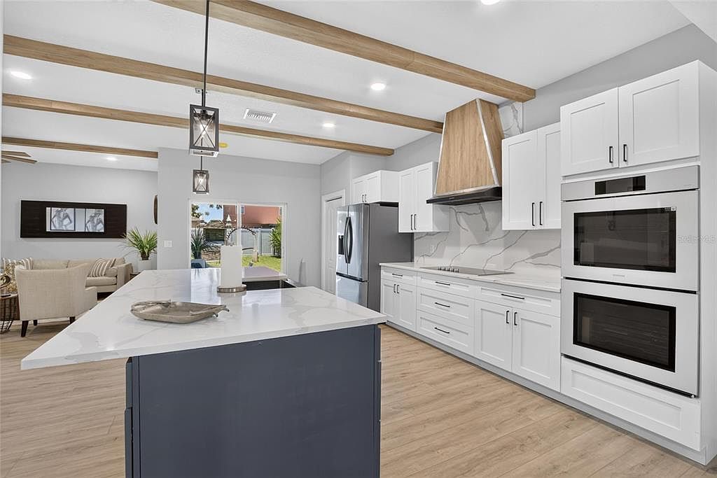 Kitchen with stone counters and built-in wall ovens at 525 19th Street NW, Ruskin