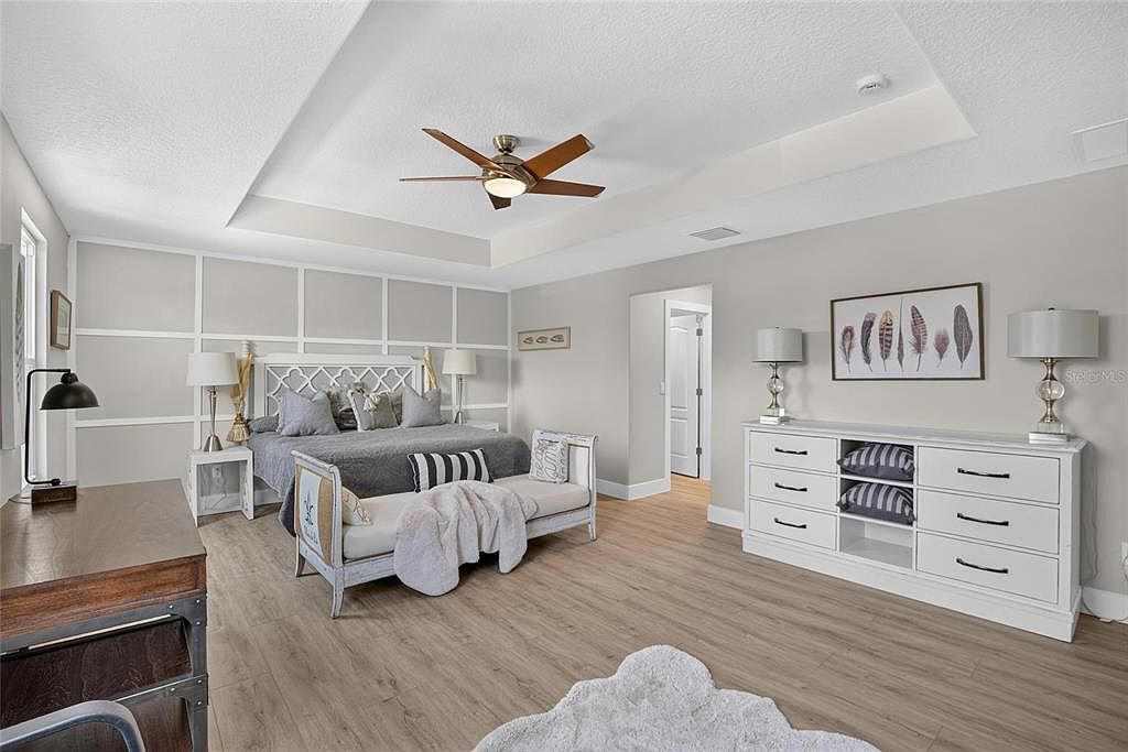 Upstairs primary suite with a tray ceiling at 525 19th Street NW, Ruskin