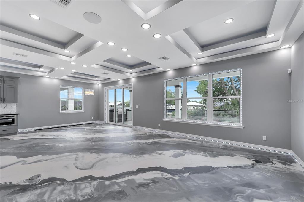 Living area with fireplace and tray ceilings at 534 Estuary Shore Lane