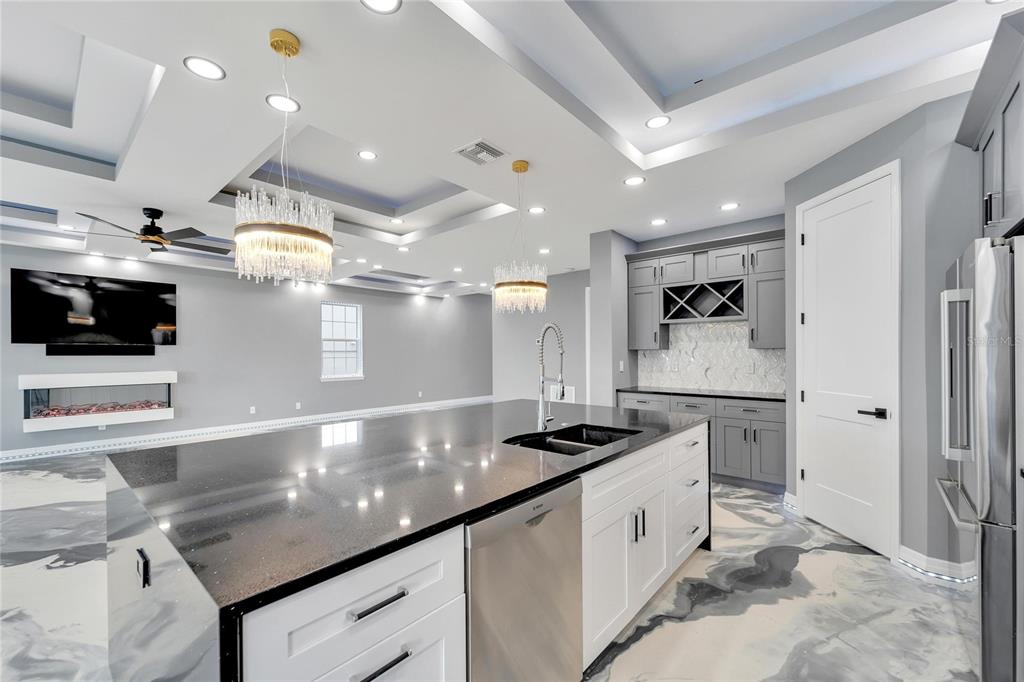 Kitchen with quartz waterfall island and custom cabinetry at 534 Estuary Shore Lane