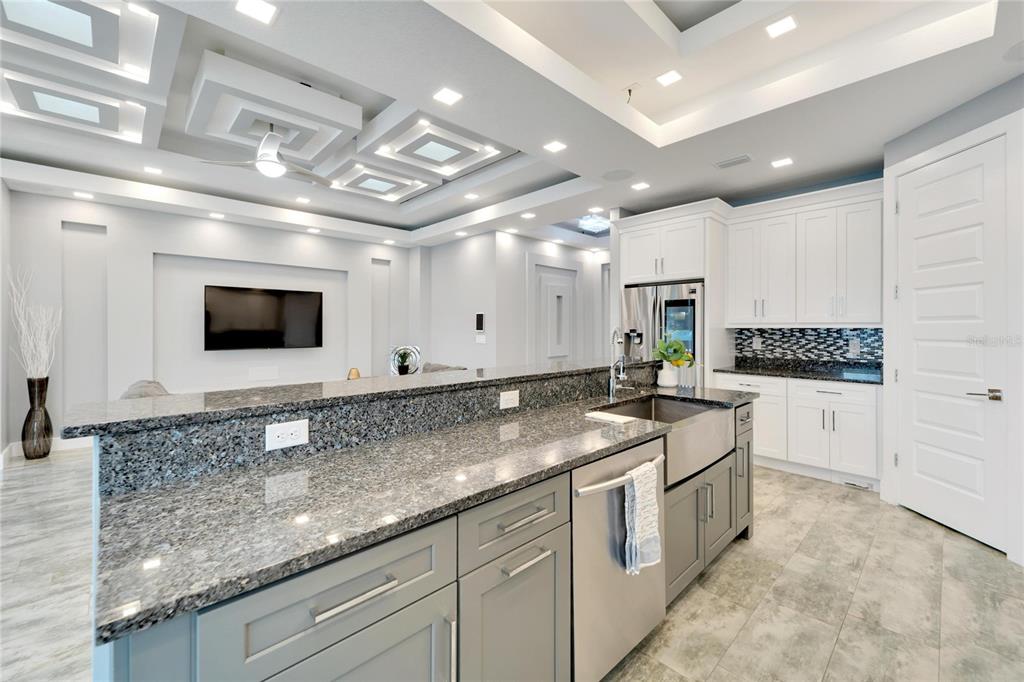 Kitchen with quartz counters, gas stove and dual-level island