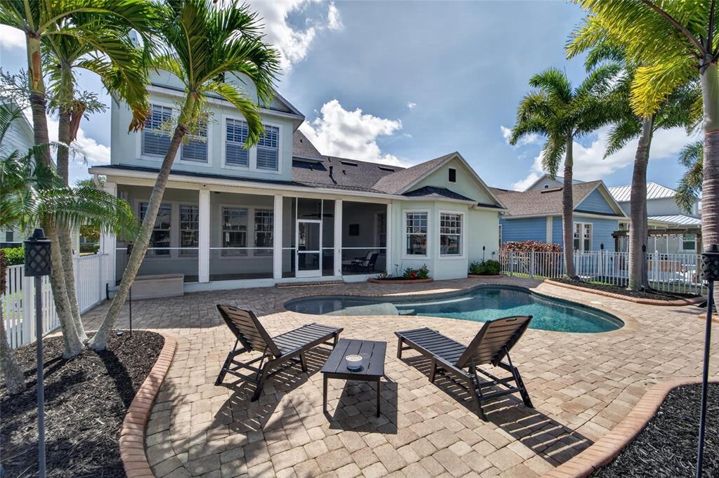 Pool deck with stone pavers and foxtail palms