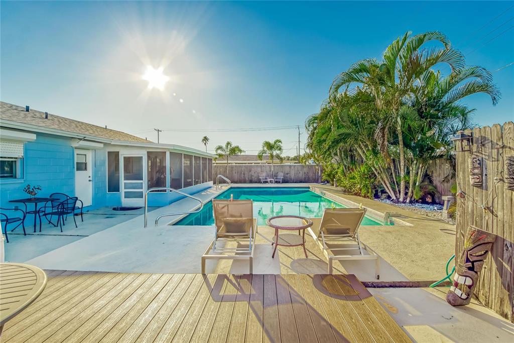 Pool surrounded by mature coastal landscaping