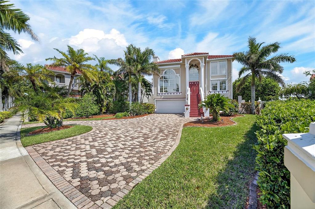 Front of 6107 Marbella Boulevard with circular paver driveway