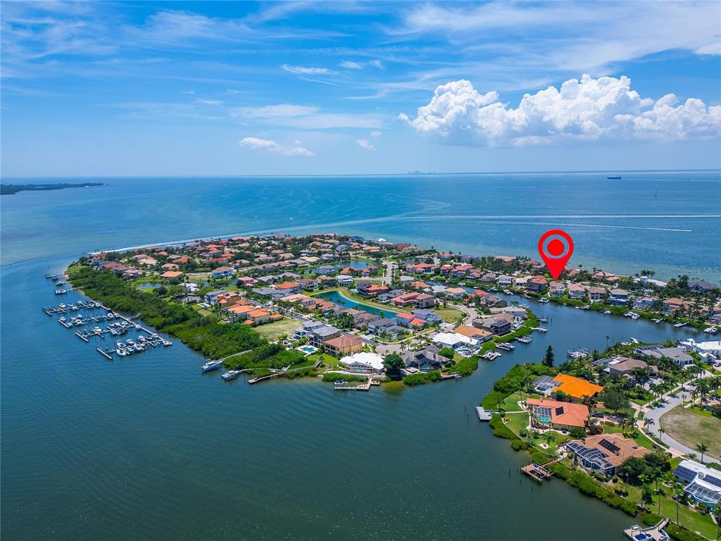 Aerial of the Andalucía canals and harbor around 6203 Marbella Boulevard with Tampa Bay beyond