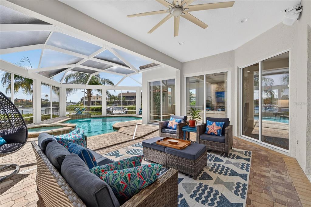 Covered outdoor living and kitchen overlooking the canal at 6203 Marbella Boulevard