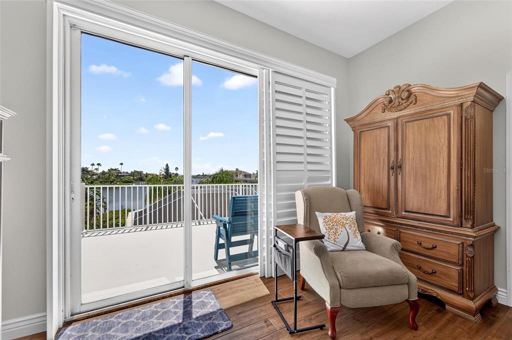 Waterfront balcony off the primary suite and media room at 6203 Marbella Boulevard