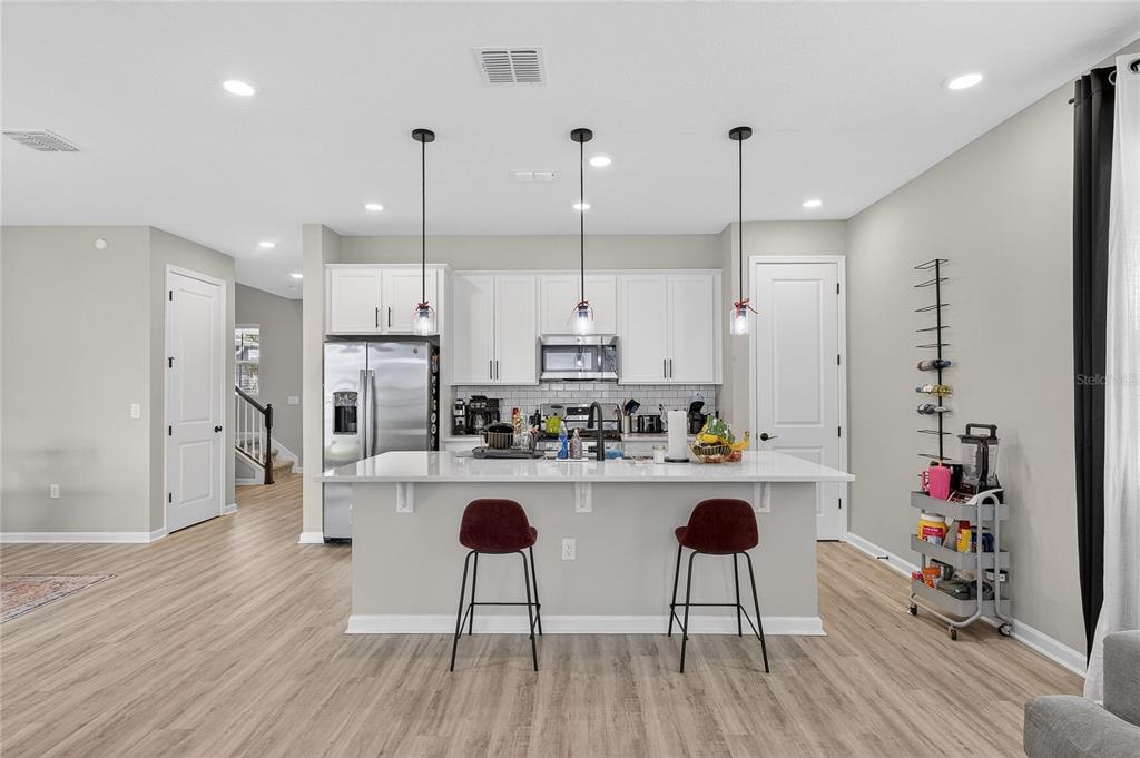 Kitchen with island, stone counters and solid wood cabinets
