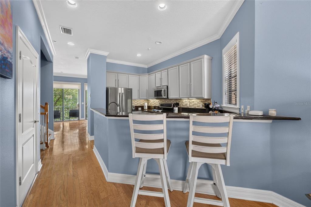 Kitchen with refinished cabinets and solid-surface counters