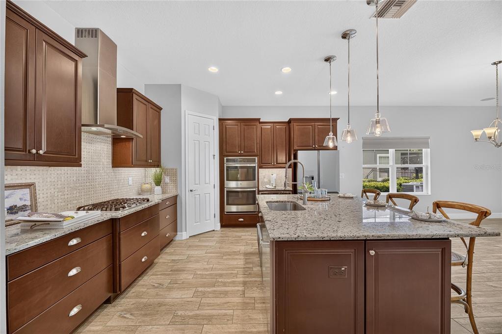 Kitchen with island, stone counters and solid wood cabinets