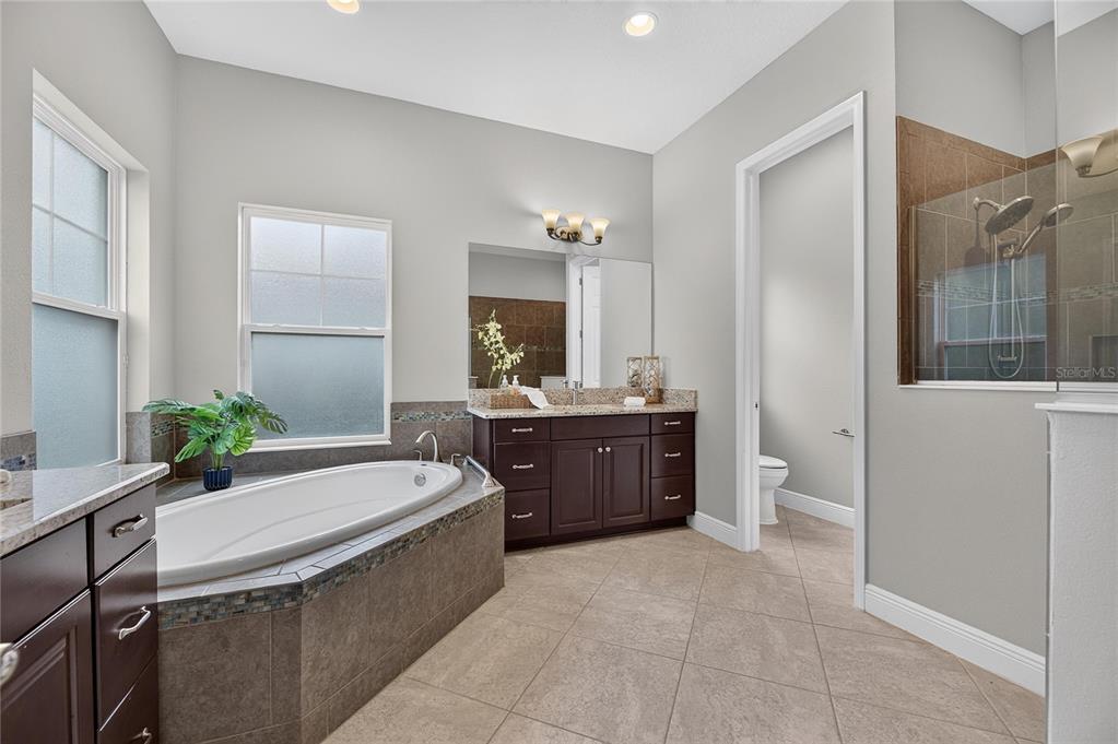 Primary bath with split vanities and separate tub and shower