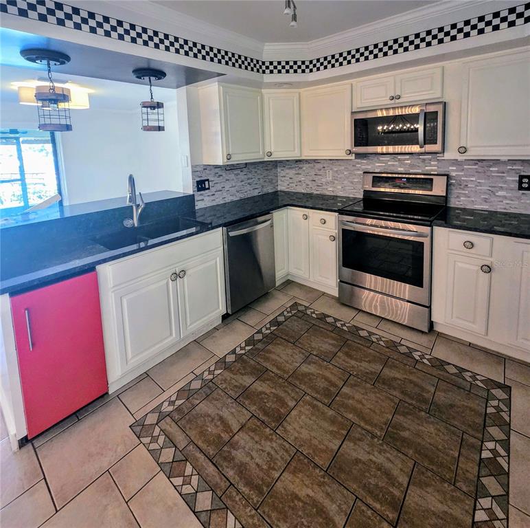 Kitchen with imported island and hardwood cabinets