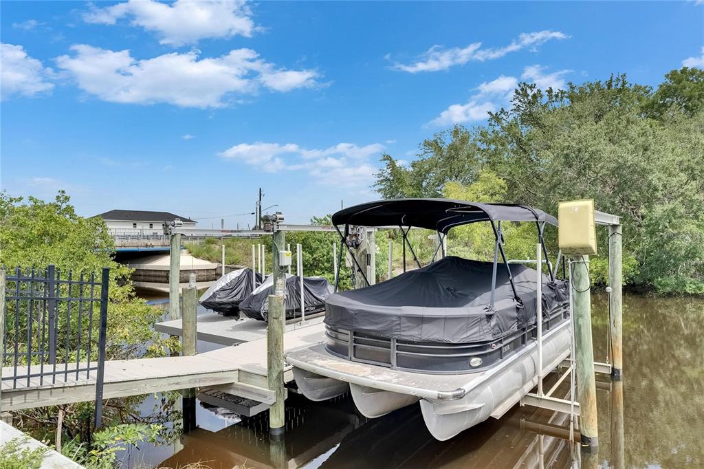 Two private docks with a boat lift and a double jet ski lift at 6512 Simone Shores Circle