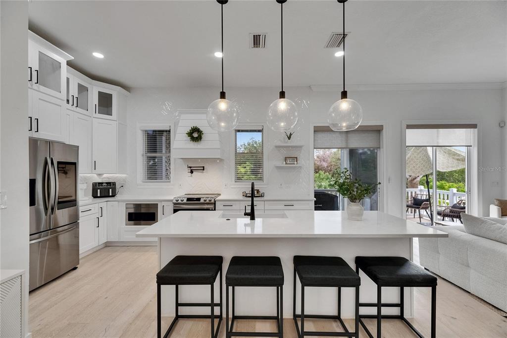Remodeled kitchen with island seating and stainless appliances at 6512 Simone Shores Circle