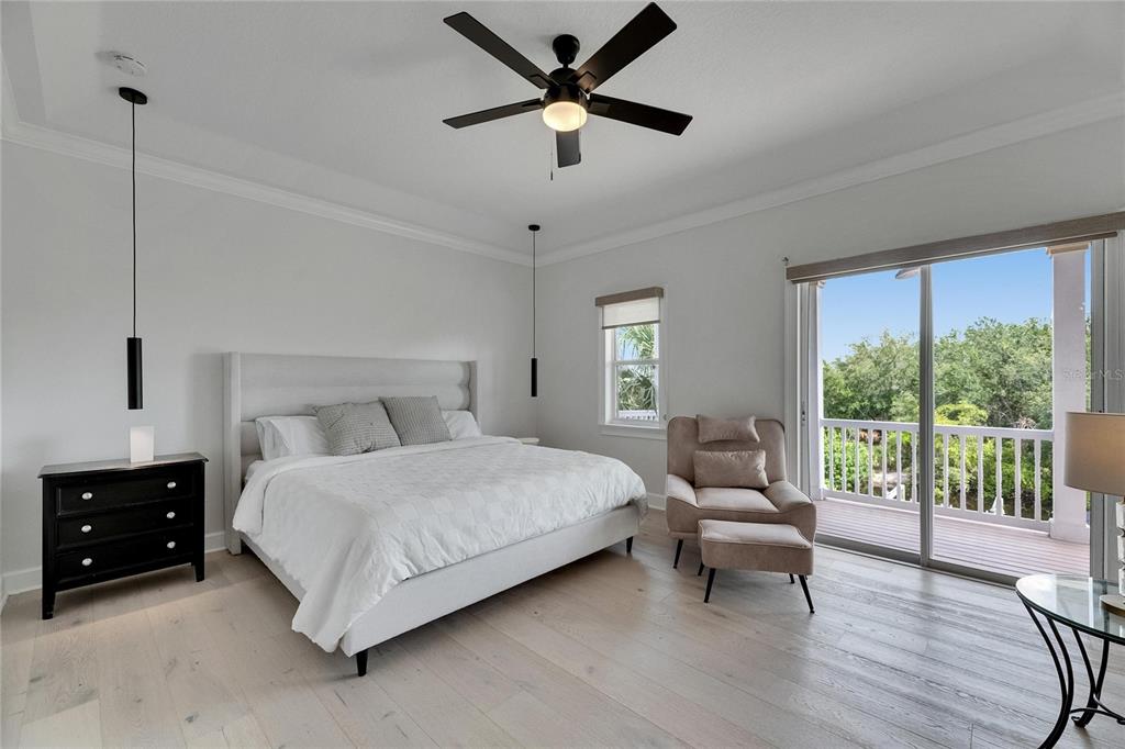 Upstairs bedroom with balcony doors at 6512 Simone Shores Circle
