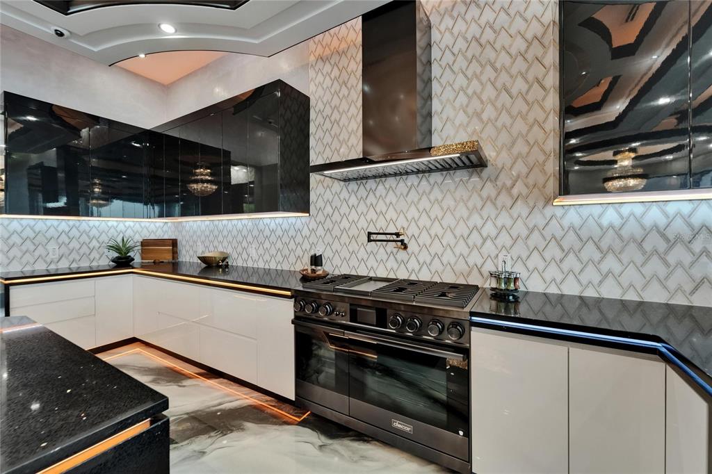 Chef’s kitchen with double ovens and center island at 6526 Surfside Boulevard