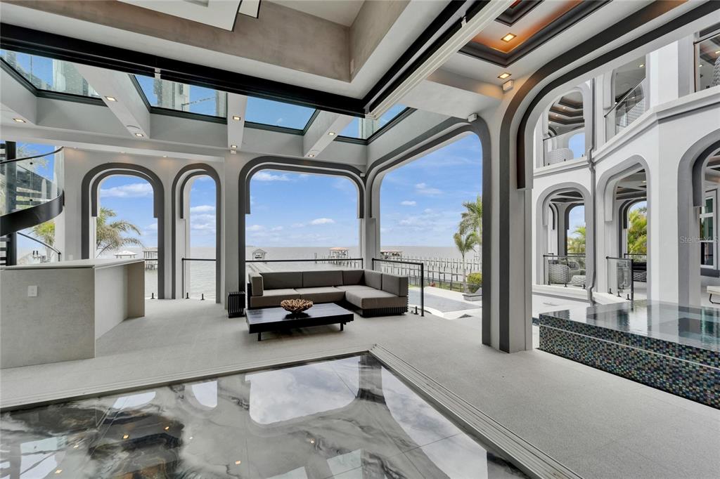 Main living area with venetian plaster walls and bay views at 6526 Surfside Boulevard