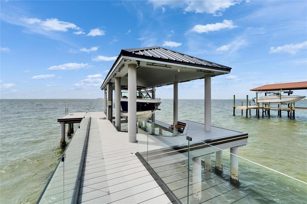 Wraparound balcony with glass railing overlooking Tampa Bay at 6526 Surfside Boulevard