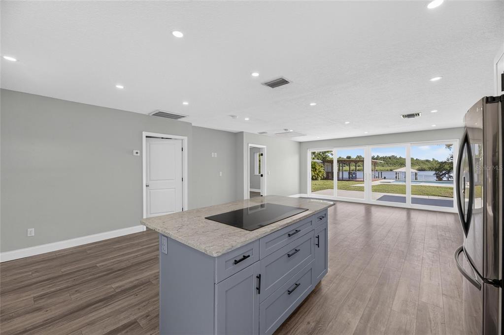 2021 remodeled kitchen with wood cabinetry, granite and island at 6712 Myrna Drive