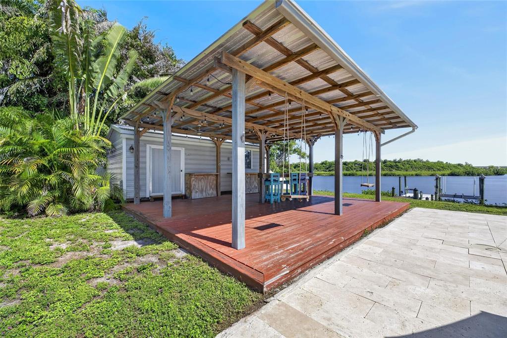 Wooden deck with covered cabana and outdoor bar at 6712 Myrna Drive