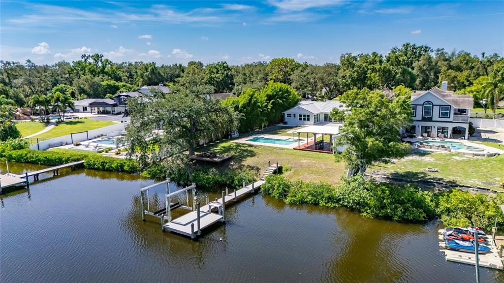 Aerial of 6712 Myrna Drive on the Palm River in Tampa with the dock, pool and 0.45 acre lot