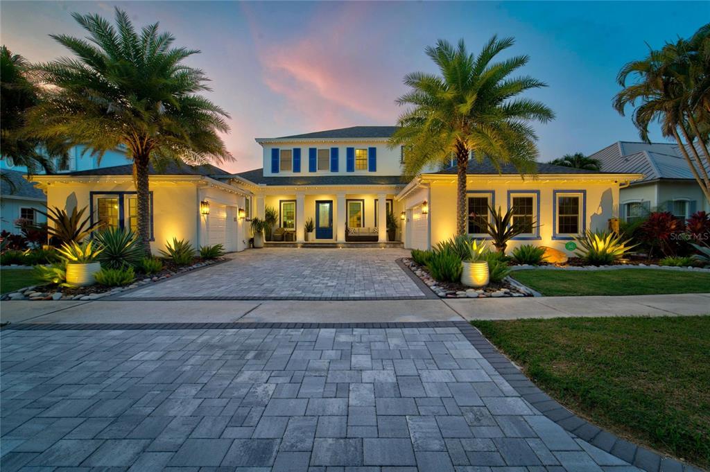 Front of 713 Islebay Drive at dusk with architectural and Trimlight exterior lighting, MiraBay, Apollo Beach FL