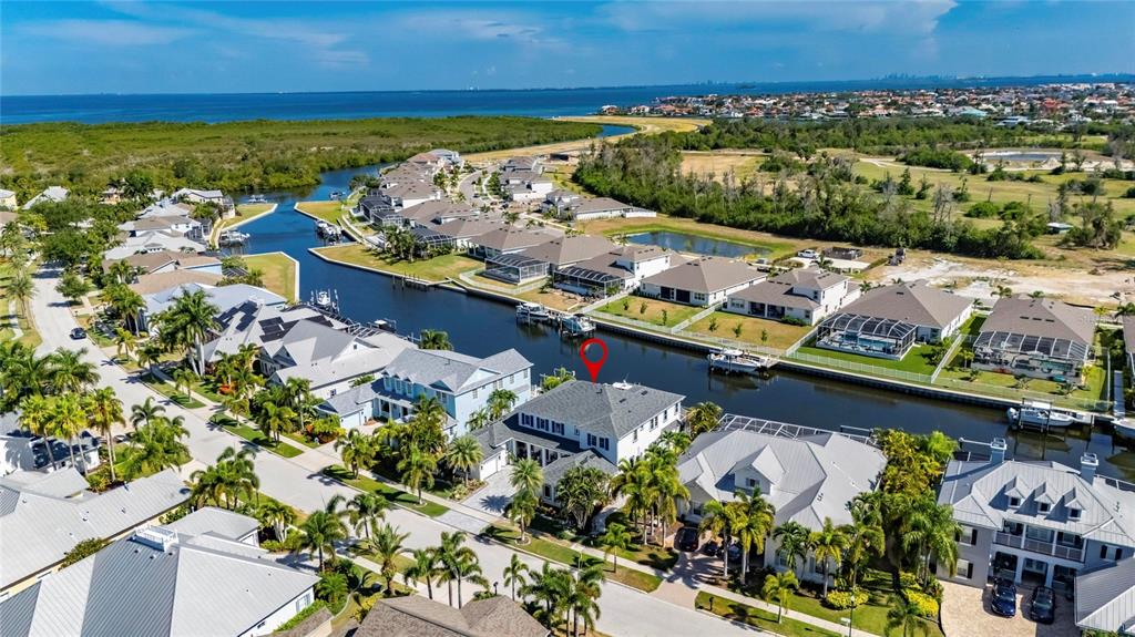 Aerial of the MiraBay canals around 713 Islebay Drive with Tampa Bay in the distance