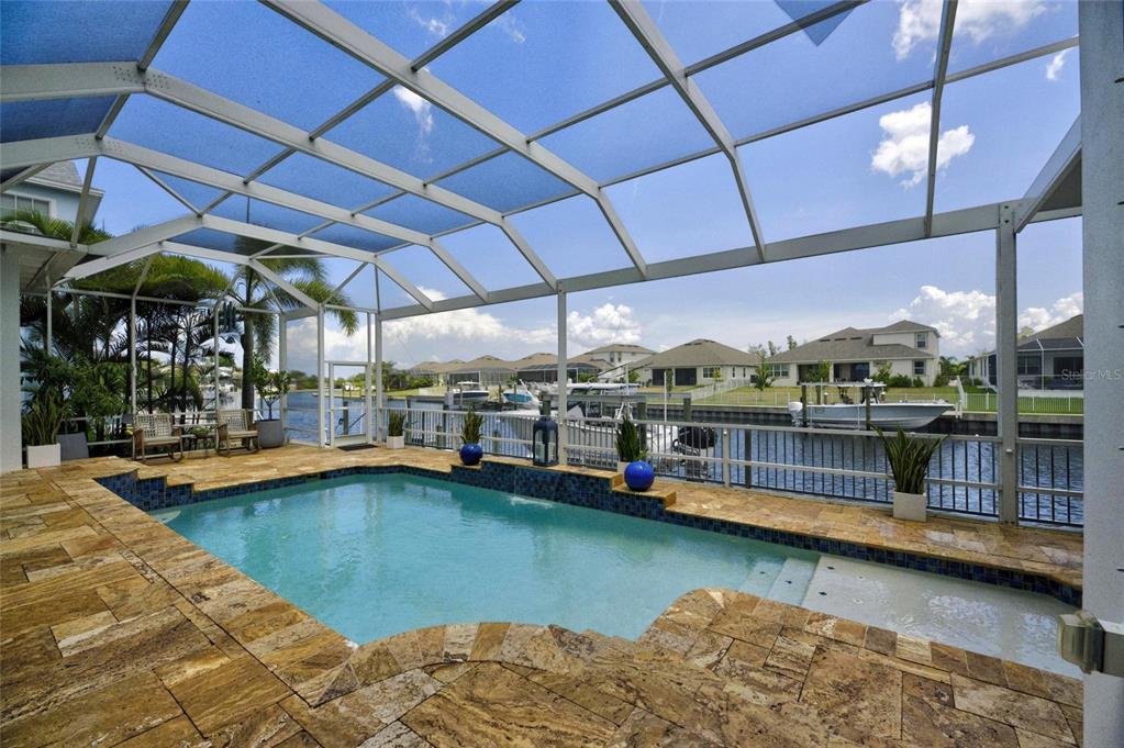 Screened heated pool with canal views at 713 Islebay Drive, MiraBay