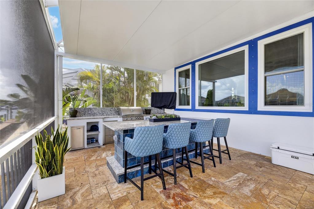 Outdoor kitchen with center island on the lanai at 713 Islebay Drive