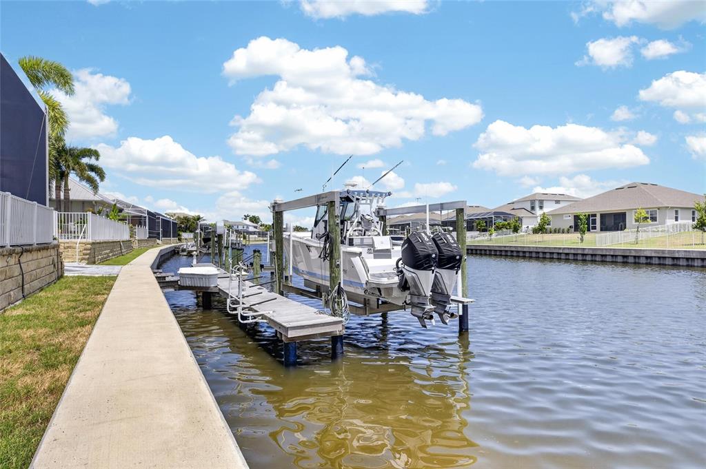 Private dock with a 13,000 pound remote-controlled boat lift at 713 Islebay Drive